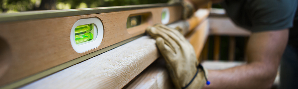 picture of worker leveling a deck